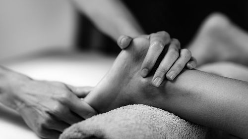 Ayurvedic foot massage. hands of ayurveda practitioner massaging female foot