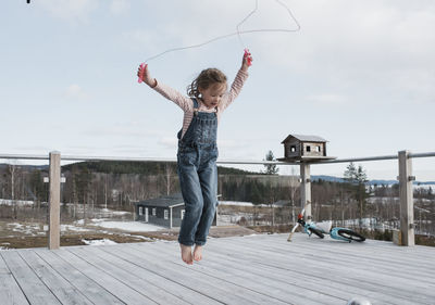 Girl skipping on her balcony outside in sweden