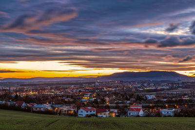 High angle shot of townscape against sky at sunset