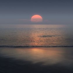 Scenic view of sea against sky at sunset