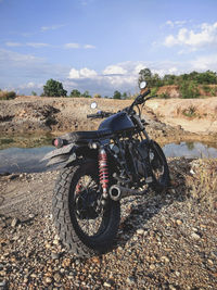 Motorcycle on dirt against sky