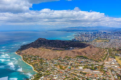 High angle view of townscape by sea against sky