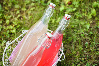 High angle view of red bottle on field