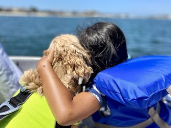 Rear view of people at sea shore