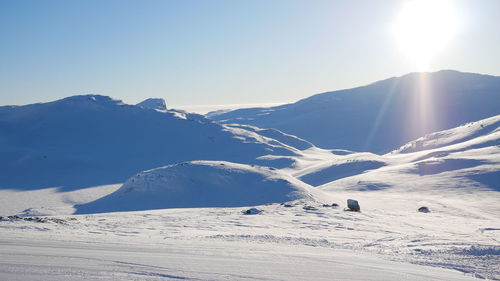 Scenic view of snowcapped mountains against clear sky