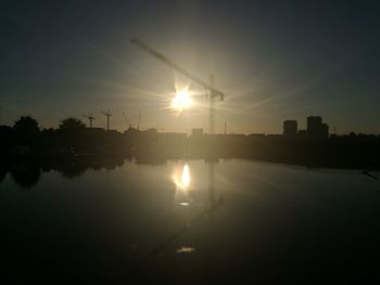 Scenic view of silhouette buildings against sky during sunset