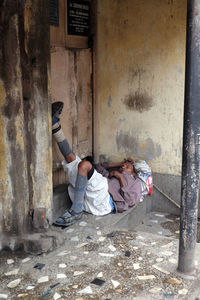 Friends resting on wall