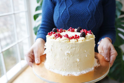 Fruit cake in female hands 