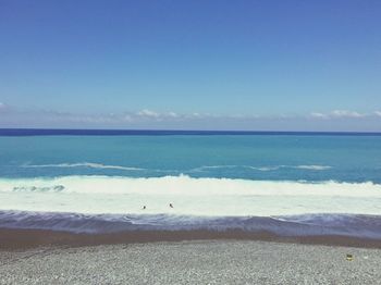 Scenic view of sea against clear blue sky