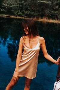 Midsection of woman standing in water