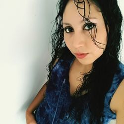 Close-up portrait of beautiful young woman over white background