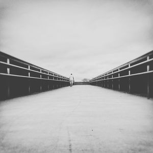 Footbridge over road against sky