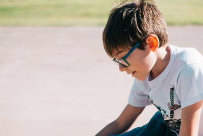 Profile view of boy wearing glasses