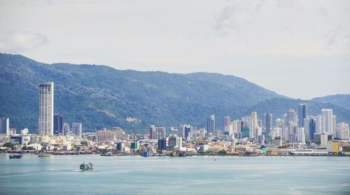 Scenic view of sea and city against sky