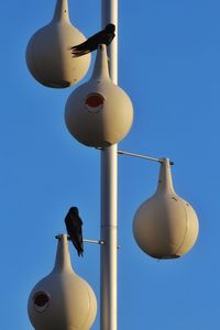 Low angle view of lamp against blue sky