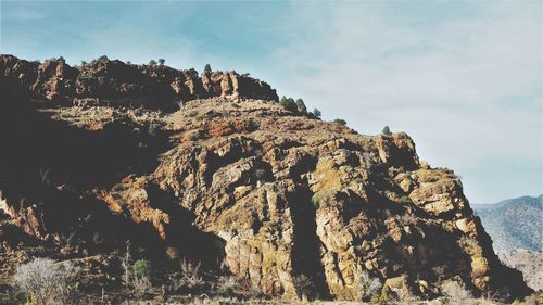 Rock formations on mountain against sky