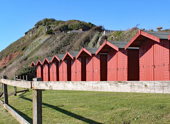 Built structure on field against clear blue sky