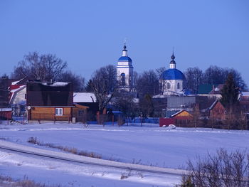 Buildings against clear sky during winter
