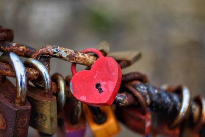 Close-up of padlocks on rusty metallic chain