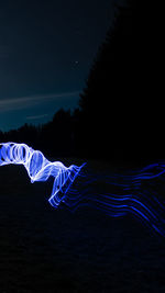 Light painting against blue sky at night