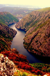 High angle view of river amidst mountains against sky