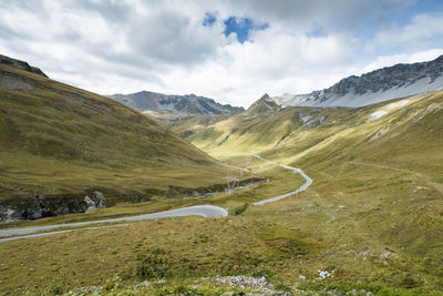 Scenic view of mountains against cloudy sky