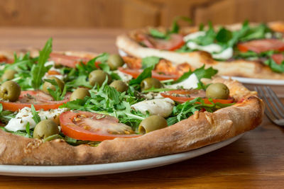 Close-up of pizza in plate on table