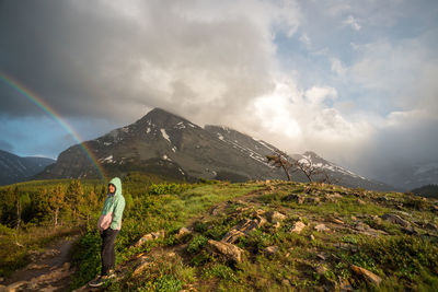 Man standing on mountain against sky