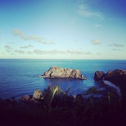 Scenic view of sea against blue sky