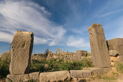 Low angle view of rock formation against sky