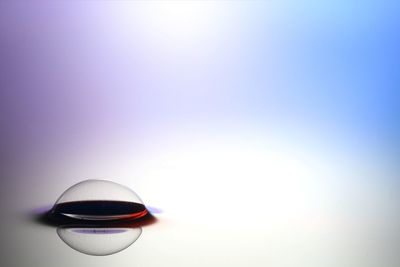 Close-up of wineglass over white background