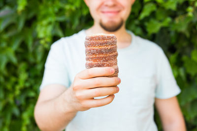 Midsection of man holding ice cream