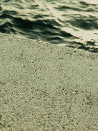 High angle view of footprints on sandy beach