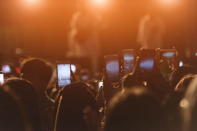 People photographing at music concert