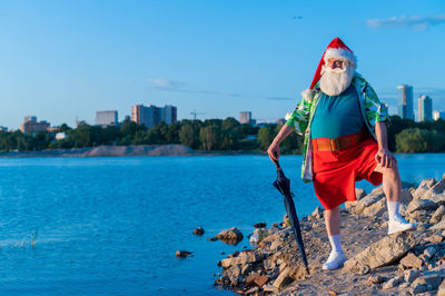 Santa clause standing by river