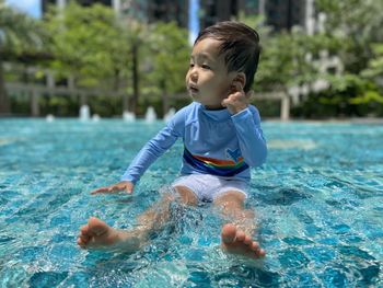 Portrait of boy playing in swimming pool