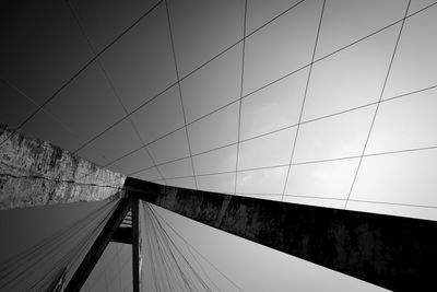 Low angle view of suspension bridge against sky