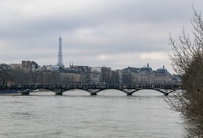 Bridge over river with city in background