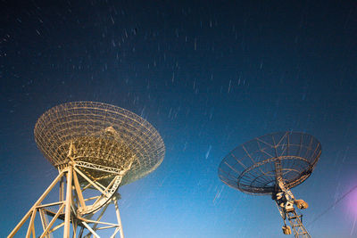 Low angle view of communications tower against clear sky at night