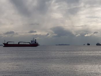 Ship sailing on sea against sky