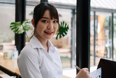 Portrait of young businesswoman working in office