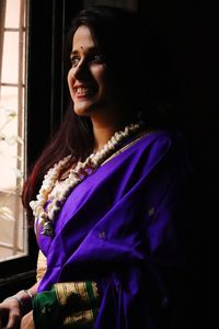 Portrait of a smiling young woman at home