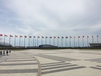 Various flag waving against sky