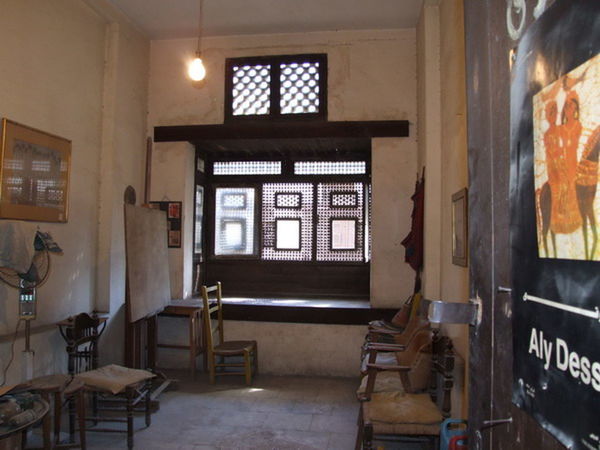 EMPTY CHAIRS AND TABLE IN ILLUMINATED BUILDING