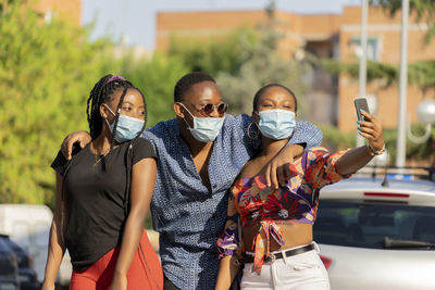 Group of africans with their smartphones around the city