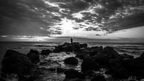 Scenic view of sea against cloudy sky