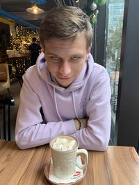 Portrait of man with coffee cup in restaurant