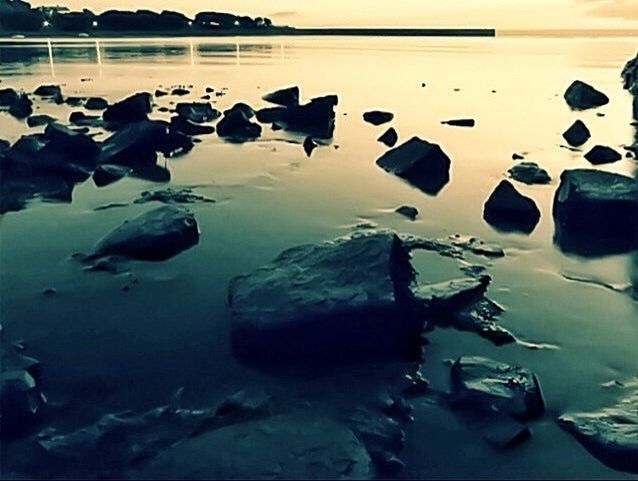 water, reflection, tranquility, nature, tranquil scene, rock - object, beauty in nature, sky, sea, no people, outdoors, standing water, scenics, lake, transportation, stone - object, day, high angle view, leaf, close-up