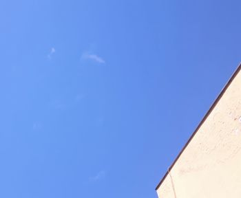 Low angle view of building against blue sky