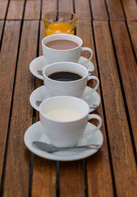 Cups arranged in plates on wooden table